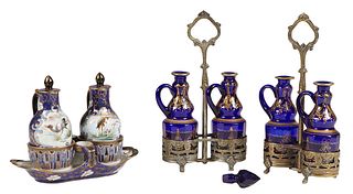Group of Three Two Bottle Cruet Sets, early 20th c., two of blue glass with gilt decoration in silverplated caddies, together with a porcelain example