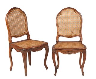 Pair of French Louis XV Style Carved Walnut Side Chairs, early 20th c., the arched floral carved caned back, to a bowed seat, on cabriole legs, joined