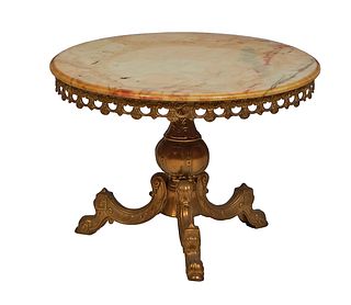 French Brass Louis XVI Style Marble Top Coffee Table, 20th c., the ogee edge highly figured circular ocher marble over a pierced brass skirt, on a tap
