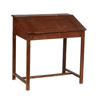 French Provincial Carved Pitchpine School Desk, c. 1900, the slanted hinged top lifting to open storage, on square legs, joined by a rectangular H-for