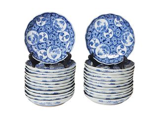 Set of Twenty-Four Japanese Blue and White Porcelain Arita Imari Saucer Dishes, 20th c., each lightly scalloped and decorated in underglaze blue with 