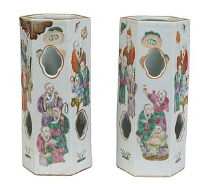 Pair of Chinese Famille Rose Hat Stands, 20th c., of hexagonal form, the pierced sides with figural, bat and dragon decoration, with a stamped red sea
