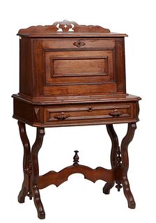 Diminutive American Carved Walnut Eastlake Slant Front Desk, c. 1880, with a pierced crest over a fall front desk with an inset baize lined writing su