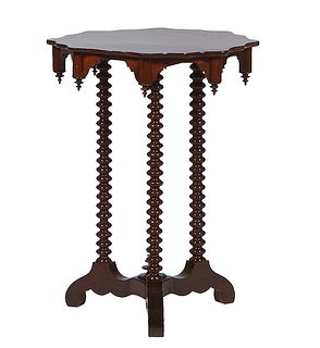 American Victorian Carved Mahogany Lamp Table, late 19th c., the scalloped circular top on three bobbin tuned supports to a base with scrolled legs ar
