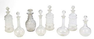 Group of Eight Glass Decanters, early 20th c., seven with etched decoration, one cut glass, Largest- H.- 11 1/2 in., Dia.- 4 in. Provenance: from the 