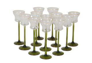 Set of Twelve Etched Crystal Long Stem Wine Glasses, 20th c., with gilt rims over floral etching on a green glass stem to a gilt rimmed green circular