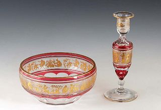 Two Pieces of Val St. Lambert Cranberry-to-Clear Cut Crystal, consisting of a gilt decorated baluster candlestick and center bowl, both with gilt band