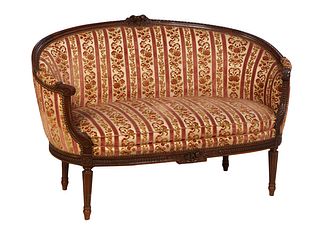 French Louis XVI Style Carved Beech Settee, 20th c., the floral carved arched upholstered back to upholstered arms above a cushioned bowed seat, on tu