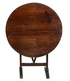 French Provincial Carved Pine Wine Tasting Table, 19th c., the circular tilt top on trestle supports with splayed legs, H.- Closed- 42 in., W.- 32 in.