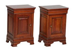 Pair of Louis Philippe Carved Cherry Nightstands, 20th c., the rounded corner top over a frieze drawer and a cupboard door,on a stepped base with brac