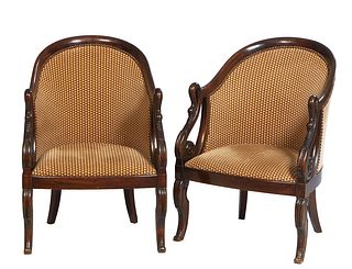Pair of French Empire Style Carved Walnut Bergeres, 19th c., the curved back to swan carved scrolled arms, on scrolled saber legs, upholstered in tan 
