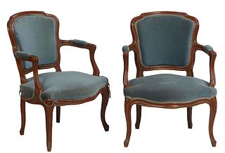 Pair of French Louis XV Style Carved Beech Fauteuils, 20th c., the arched floral carved canted curved shield back over upholstered arms and a bowed se