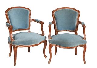 Pair of Louis XV Style Carved Beech Fauteuils, 20th c., the curved upholstered shield back over upholstered curved arms, to a bowed upholstered seat, 