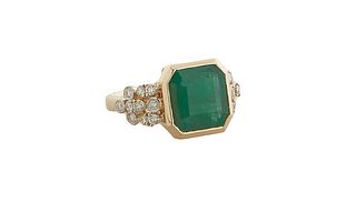 Lady's 14K Yellow Gold Dinner Ring, with a rectangular 6.25 ct. emerald within an octagonal gold border, the lugs mounted with small round diamonds, t