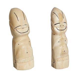 Pair of Inuit Carved Walrus Ivory Tooth Billikens, 20th c., with scrimshaw decoration, one signed on the underside "Tommy Topsekok, Nome Alaska, 1972.