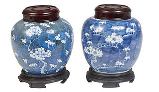 Near Pair of Chinese Blue and White Porcelain Ginger Jars, 20th c., with floral decoration, now with carved mahogany covers and stands, H.- 7 in., Dia