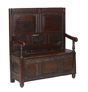 French Renaissance Style Carved Oak Bench, 19th c., the incise carved crest rail over fielded panels and scrolled arms, flanking a lift top storage ar