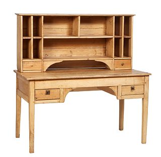 French Provincial Louis Philippe Carved Poplar Desk, 19th c., the rounded corner top over eleven cubbyholes and open storage, above two bottom drawers