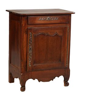 French Louis XV Style Carved Walnut Confiturier, 19th c., the rounded corner ogee edge top over a setback frieze drawer with a long iron escutcheon, a