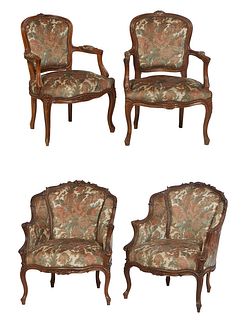 Four Louis XV Style Fauteuils, 20th c., consisting of a pair with floral carved crests over shield shaped upholstered backs to upholstered arms and bo