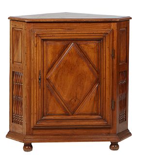 French Louis XIII Style Carved Walnut Corner Cabinet, late 19th c., the stepped rounded edge top over a large cupboard door with applied geometric dec