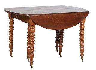 French Louis Philippe Carved Walnut Drop Leaf Table, 19th c., the oval reeded edge top over a wide skirt, on turned tapered cylindrical legs with bras