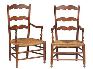 Pair of French Provincial Carved Beech Rushseat Armchairs, 20th c., the arched ladderbacks to curved arms over bowed rush seats, on cylindrical legs j