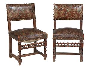 Pair of Louis XIII Style Carved Walnut Side Chairs, 19th c., with leaf and floral embossed and painted leather backs and seats with iron tack decorati
