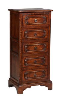 French Provincial Carved Oak Chiffonier, 20th c., the stepped rounded corner top over a bank of five drawers, on a plinth base with bracket feet, H.- 