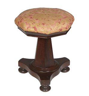 American Classical Carved Mahogany Adjustable Piano Stool, 19th c., the cushioned octagonal top over a tapering skirt, on a hexagonal support on trian