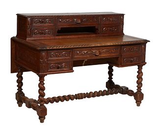 Unusual French Henri II Style Carved Oak Desk, c. 1880, the super structure fitted with five drawers and open storage on a carved edge base with a rea