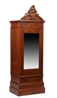 Diminutive American Eastlake Style Carved Mahogany Armoire, c. 1890, the arched scroll carve crest atop a stepped architectural crown over a single wi