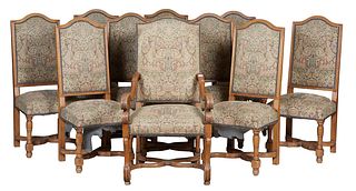 Set of Ten Louis XIII Style Carved Oak Upholstered Dining Chairs, 20th c., the arched high backs over trapezoidal seats, on turned and block legs join