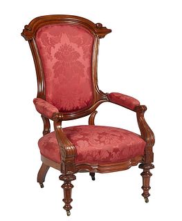 American Victorian Carved Walnut Parlor Chair, 19th c., the scroll carved arched crest rail over a canted upholstered back to upholstered arms above a