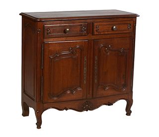 French Provincial Louis XV Style Carved Oak Sideboard, early 20th c., the stepped rounded edge and corner top over two frieze drawers, above double fi