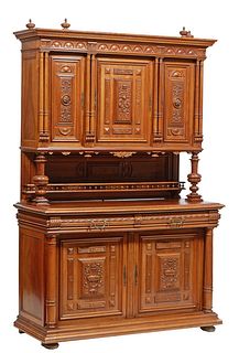 French Provincial Carved Walnut Buffet a Deux Corps, c. 1880, the upper section with a scrolled stepped crown, over triple relief carved cupboards fla