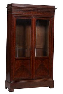 French Louis XVI Style Carved Walnut Bookcase, 19th c., with a stepped cookie corner over double doors with glazed upper panels over wood lower panels