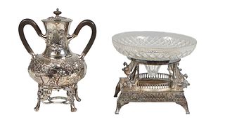 Two Pieces of Silverplate, early 20th c., consisting of a repousse hot water urn, with grape and leaf decoration and ebonized wood; together with a la