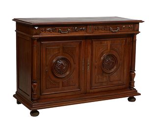 French Henri II Style Carved Walnut Sideboard, c. 1880, the stepped top over two setback frieze drawers above two incise carved cupboard doors, flanke