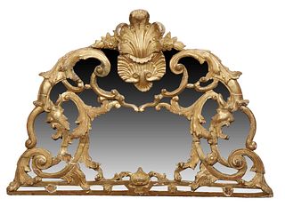 English Gilt and Gesso Overmantel Mirror, 19th c., with a center shell and prince of Wales feathers carving above arched pierced sides and a pierced b