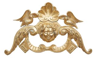 Gilt Carved Wood Architectural Element, 20th c., with a shell carved top flanked by birds, over a putto head flanked by scrolled leaves, H.- 18 in., W