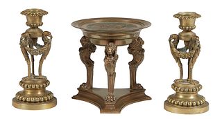 Three Bronze Items, 19th c., consisting of a pair of empire style candlesticks, on bird form supports joined by floral garlands, on a stepped beaded c