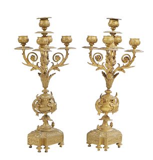 Pair of French Gilt Bronze Five Light Candelabra, 19th c., with a central candle cup above four scrolled arms with candlecups, on a relief decorated u