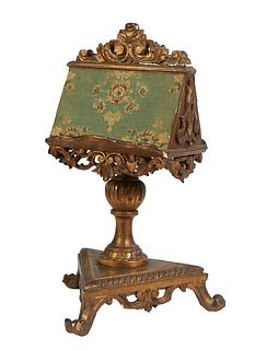 Italian Polychromed Gilt and Gesso Carved Wood Book Stand, early 20th c., double sided, with pierced scrolled skirts on an urn form support to a trian