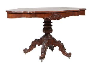 French Louis Philippe Carved Walnut Center Table, late 19th c., the serpentine tortoise top over a wide skirt, with a center drawer on each long side,