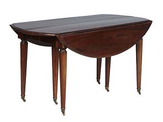 French Carved Walnut Oval Dropleaf Table, early 20th c., the stepped sloping edge oval top on tapered cylindrical legs with ormolu cap casters, openin