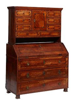 Continental Inlaid Mahogany Slant Front Secretary, 19th c., the stepped crown over a central cupboard door flanked by three small drawers on each side