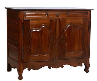 French Louis XV Style Carved Walnut Sideboard, 20th c., the rounded panel corner top, over a center setback fielded panel frieze drawer, over large do