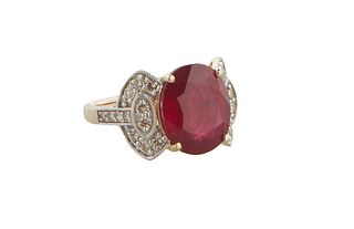 Lady's 14K yellow Gold Dinner Ring, with an oval 9.21 ct. ruby flanked by diamond mounted lugs and shoulders of the band, total diamond wt.- .61 cts.,