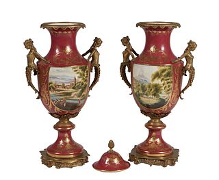 Pair of Sevres Style Gilt Decorated Porcelain Handled Covered Urns, 20th c., with figural nude female handles over a landscape and figural reserve on 